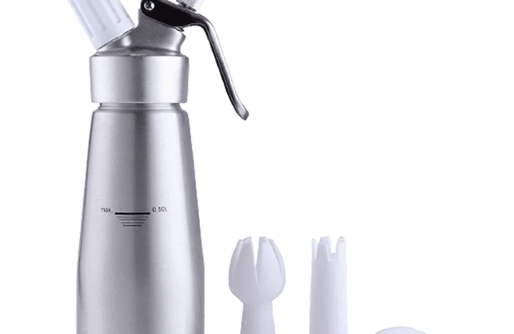 Whipped cream dispenser with decorating tips and cleaning brush