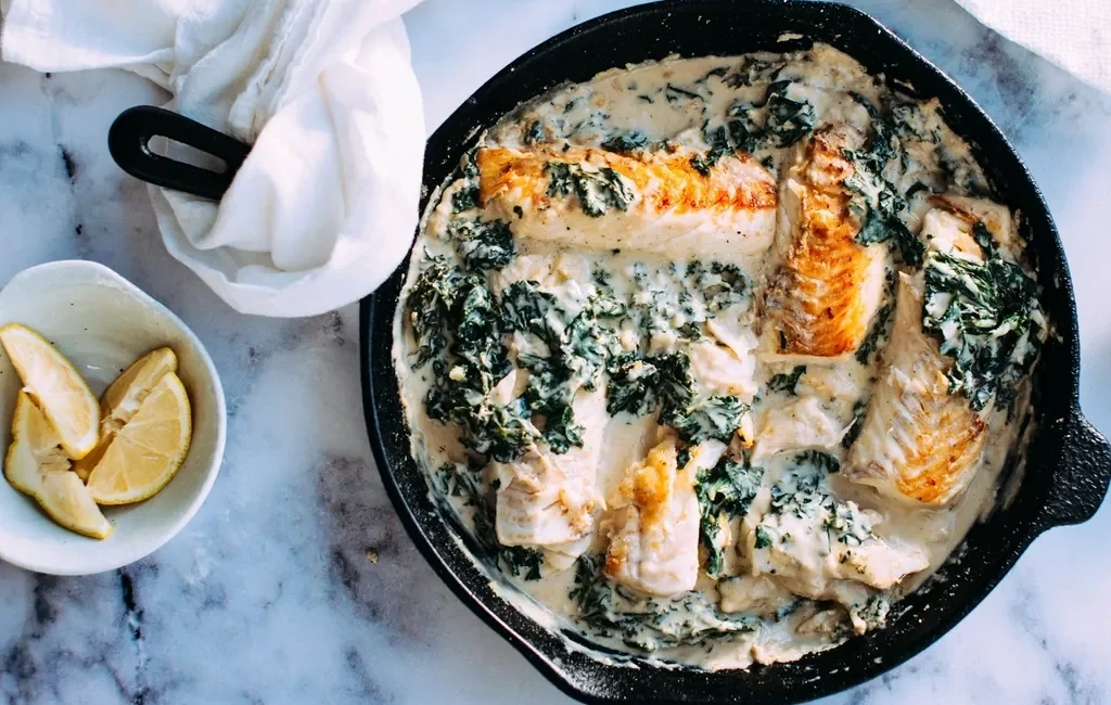Skillet of creamed spinach with salmon