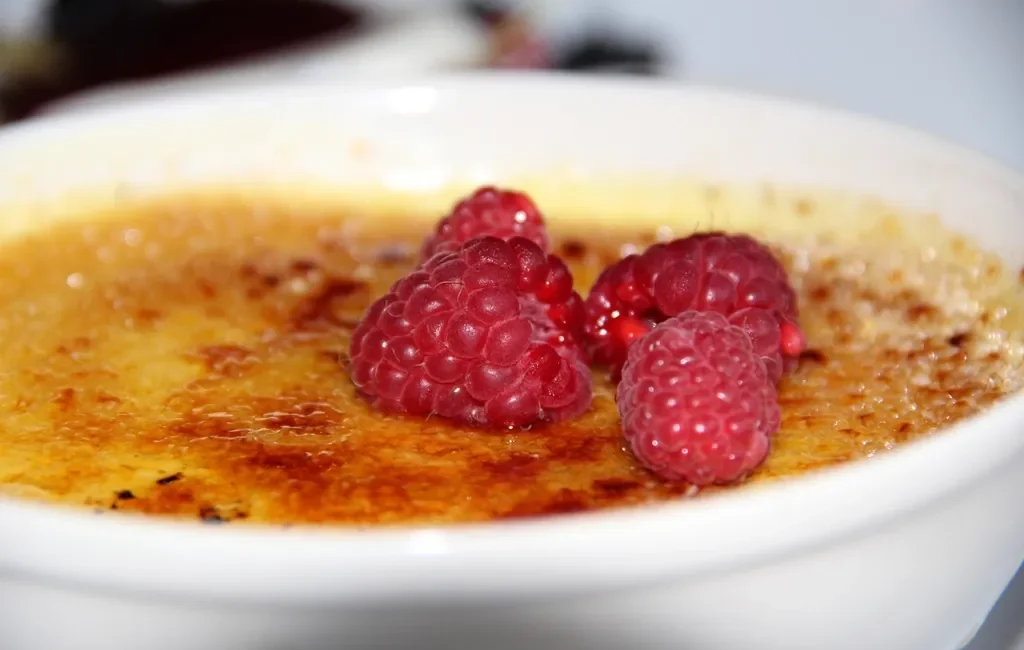 Crème brûlée topped with raspberries