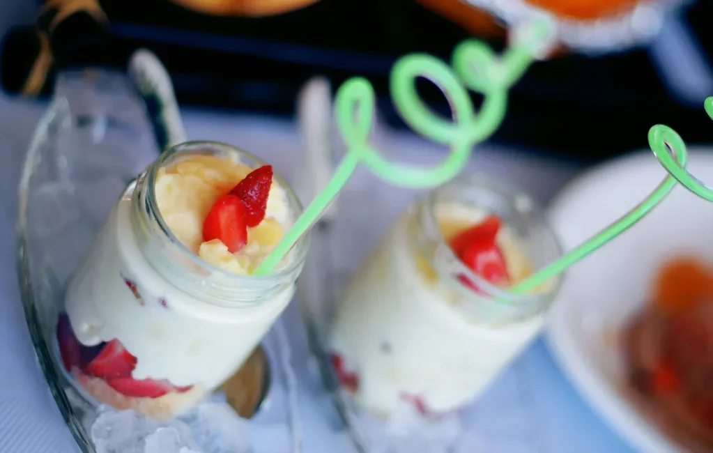 Individual cream and strawberry desserts in glasses
