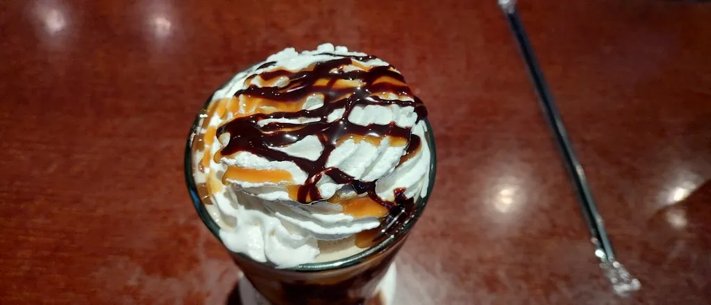 Blended chocolate drink topped with whipped cream and chocolate drizzle