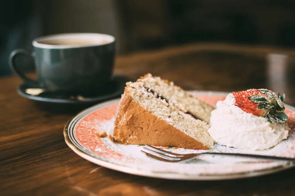 Cake slices with cream and a cup of coffee