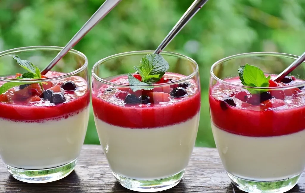 Panna cotta in glasses with berry sauce
